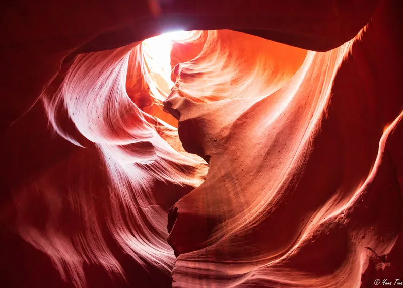 Sunlight falling through the sculpted red sandstone curves of Antelope Canyon